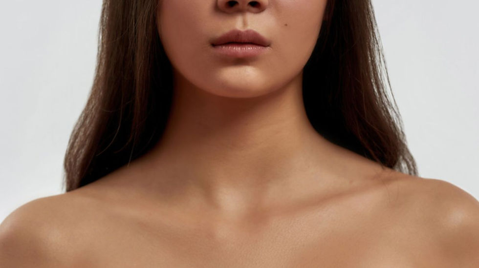 Close-up of a woman's smooth, radiant skin on her face and décolletage, showcasing natural beauty and healthy complexion
