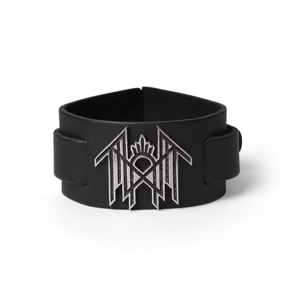 Sleep Token Logo Leather Bracelet - Antiqued Pewter Emblem on Adjustable Leather Wrist Strap Channel the mystique of Sleep Token with this powerful leather wrist strap bracelet, featuring the band's symbolic logo cast in antiqued English pewter. Set on a wide black leather strap and finished with a secure blackened pewter fastener, this bracelet captures the dark elegance and ritualistic presence that defines the band's visual identity. Handcrafted in England, the pewter emblem reflects Sleep Token's immersive aesthetic minimal, meaningful, and heavy with atmosphere. Built for fans who connect deeply with the music and the message, this bracelet is designed to be worn with intent. • Sleep Token logo in handcrafted antiqued pewter • Wide black leather strap adjustable, comfortable, and bold • Secure blackened pewter fastening for a strong, finished look • Handmade in England by expert pewter artisans • Inspired by the band's sacred, symbol-driven visual world • Ideal for fans of alternative metal, ambient rock, and immersive soundscapes A subtle yet striking tribute to Sleep Token, this leather bracelet is more than an accessory it's a reflection of what lies beneath the surface.