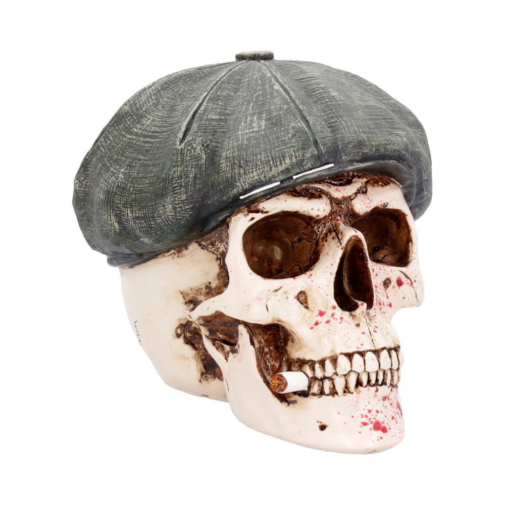 This macabre skull was created by alternative brand Nemesis Now. A grey Newsboy cap covers the top of this skull while a lit cigarette hangs out from his teeth. As you move down the skull it looks like any other until your eye catches the vivid red splatter of blood that covers the front. Cast in the finest resin before being painstakingly hand-painted, this skull is perfect for anyone who has been one the wrong side of the law.
