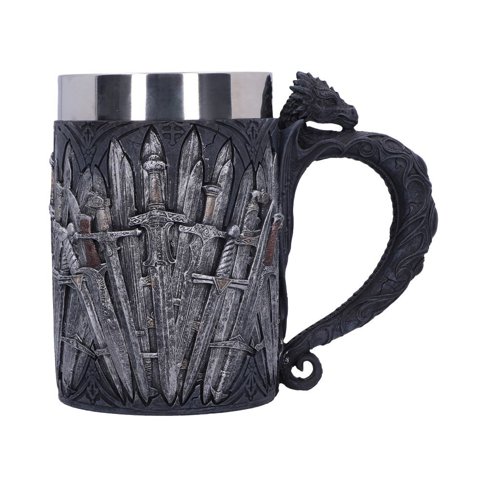 Formulated in the twisted imaginations of Nemesis Now's darkly talented in-house design team, this Sword tankard is a must-have! Curving gently outwards, the black handle has the appearance of a Dragon arching outwards, wings flat against the tankard and curled Celtic designs down the tail. The body of the tankard is emblazoned with a multitude of swords on a black background. Cast in the finest resin before being painstakingly hand-painted, this tankard comes with a removable stainless steel insert for ease of cleaning.