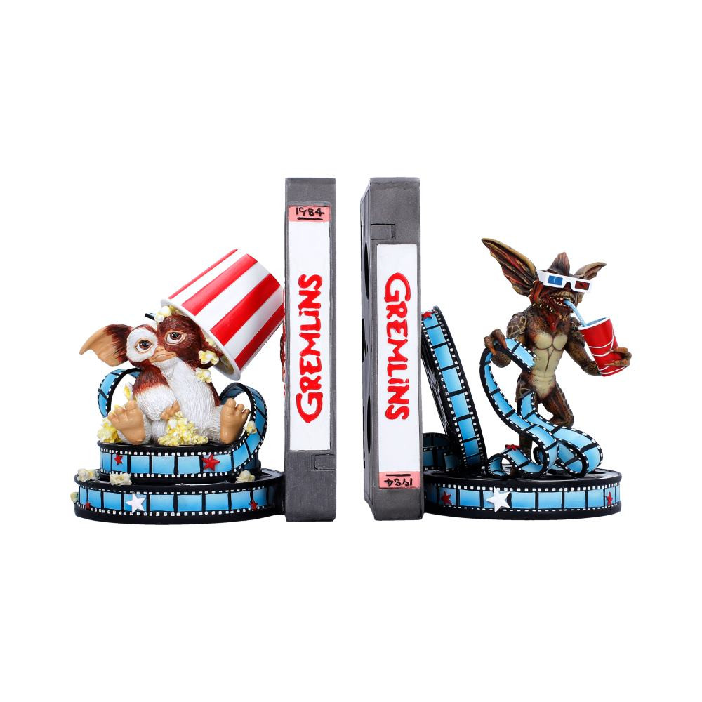 These officially licensed Gremlins Bookends from Nemesis Now take the shape of vintage VHS tapes, featuring Gizmo wrapped in a playful film reel with popcorn tumbling overhead and a mischievous Gremlin lounging in 3D glasses with a soft drink in hand. Beautifully hand-painted in the classic colours fans love, each piece includes a flexible blue film reel for added realism. Packaged in a premium collectors box with a fold-out lid, this set is perfect for Gremlins fans, movie memorabilia collectors and lovers of nostalgic decor. A fun and characterful way to bring the cult-classic charm to your shelves.