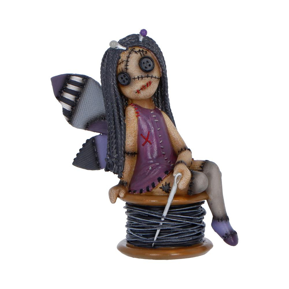 The Stitchlings Stitchy Belle from Nemesis Now is an original collectible figurine, part of the Stitchlings collection, depicting a fairy-like voodoo doll perched atop a spool of sewing thread. She features a cute-but-spooky design with a purple colour scheme, dark hair, stitched wings, button eyes and detailed stitching throughout her body. Cast in fine resin and expertly hand-painted, this compact 11.4cm tall figurine comes packaged in a branded gift box. Ideal for collectors of gothic and alternative decor, fans of quirky figurines, or anyone who loves cute-but-spooky characters, Stitchy Belle adds a charmingly eerie touch to any display.