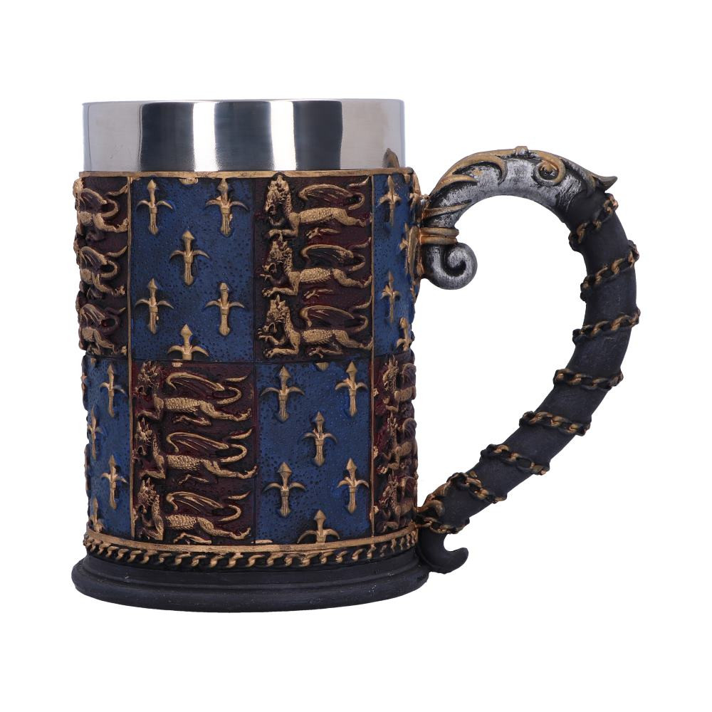Created by Nemesis Now, the main body of the tankard has a repeating pattern of the royal standard of Edward III, with 3 gold lions on a red field quartered with a pattern of gold Fleur-de-Lys arranged on a blue field. A thin gold chain circles the body just above the black base. The handle curls out from the side, black with a slender gold chain wrapped around it, with the top being enveloped in a silver sheath wild curled golden patterns wrapped around it. Cast in the finest resin before being carefully hand-painted, this tankard comes with a removable stainless-steel insert for ease of cleaning.
