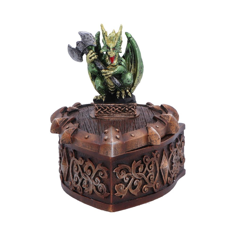 The Hoard Defender Box is an originally designed trinket box from Nemesis Now, featuring a fierce green dragon clutching a battle axe as it stands atop a shield-shaped box. Standing 10.4cm tall, the piece is rich in detail, from the vivid green dragon to the intricate fantasy patterns and sharp accents decorating the box. The removable lid reveals a small compartment perfect for storing small keepsakes, while the hand-painted finish combines dark brown and metallic-like tones that contrast strikingly with the vivid green dragon. Carefully packaged for protection, this decorative storage piece is ideal for fantasy collectors, dragon enthusiasts, and lovers of mythical decor. Bring a touch of legendary guardianship to your favourite treasures.