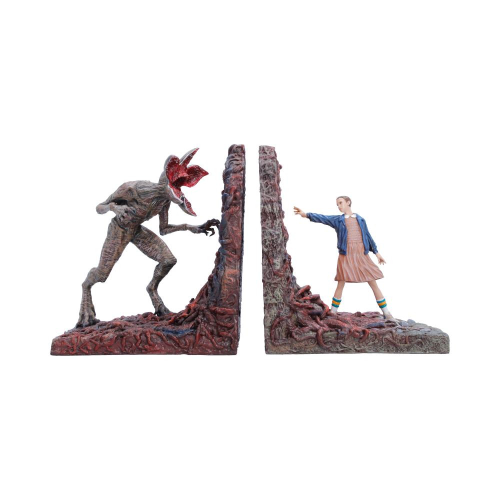 Officially licensed Stranger Things bookend set from Nemesis Now, standing at 29.4cm tall and recreating the unforgettable showdown from Season 1 between Eleven and the terrifying Demogorgon. Expertly hand-painted, the bookends feature intricate Upside Down vines, glowing gate details, and incredible character sculpting that captures every detail from Eleven's iconic outfit to the Demogorgon’s grotesque form. Packaged in a secure branded box, making it ideal for gifting, collecting, or display. Perfect for dedicated Stranger Things fans, horror collectors, and pop culture enthusiasts, these striking bookends are the perfect way to bring the eerie atmosphere of the Upside Down into your home.