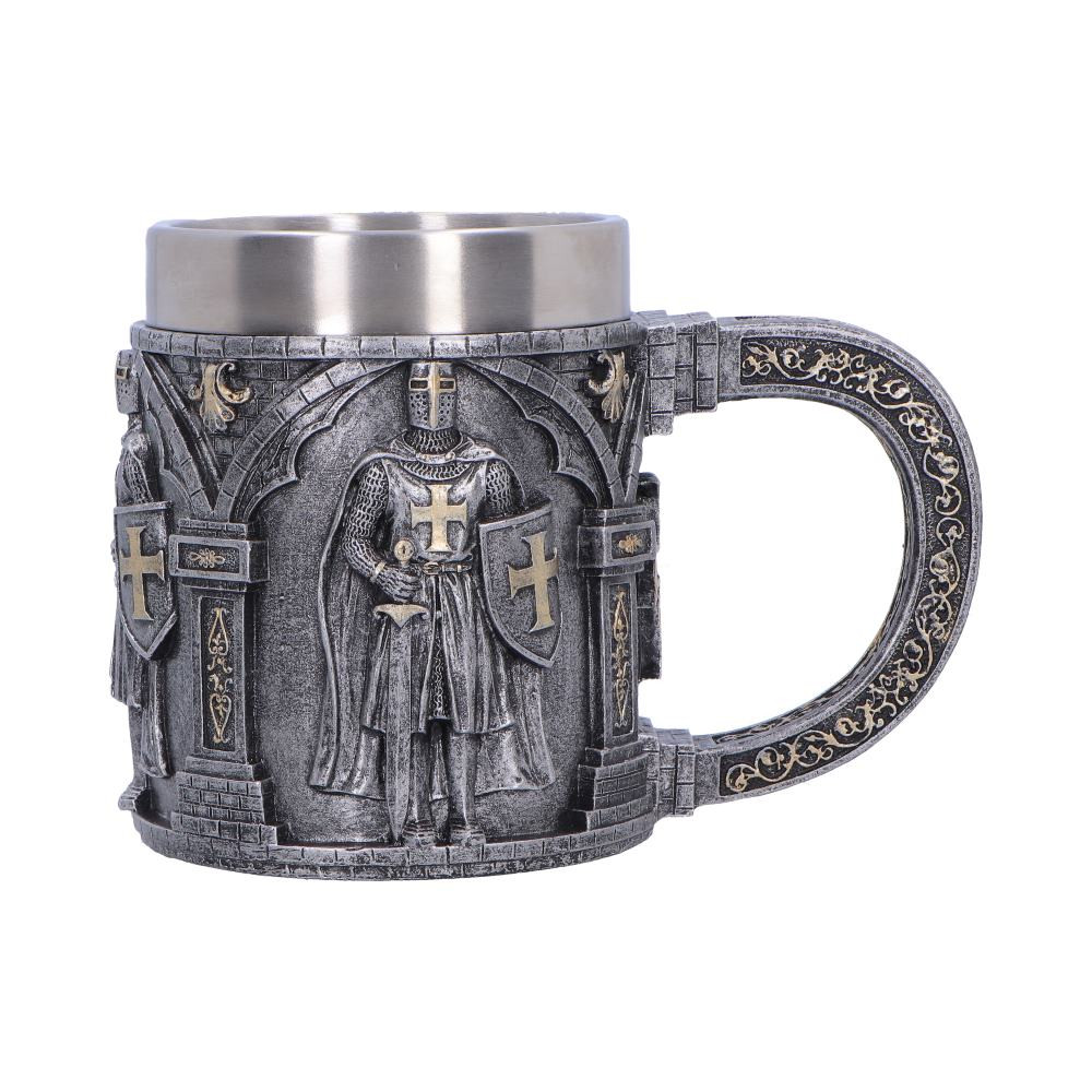 The Silver Knight Armour Tankard is a beautifully crafted miniature collectible, perfect for display or gifting. Expertly cast in high-quality resin and hand-painted in silver stone colouring, it features a detailed stone-like design adorned with crosses and portraits of knights, with gold accents on the base and handle adding a touch of medieval elegance. Packaged within a secure, branded box, it arrives shelf-ready and protected for gifting. Ideal for collectors of medieval or fantasy-themed decor and fans of unique, story-driven items, this tankard combines craftsmanship and charm for a standout addition to any home.