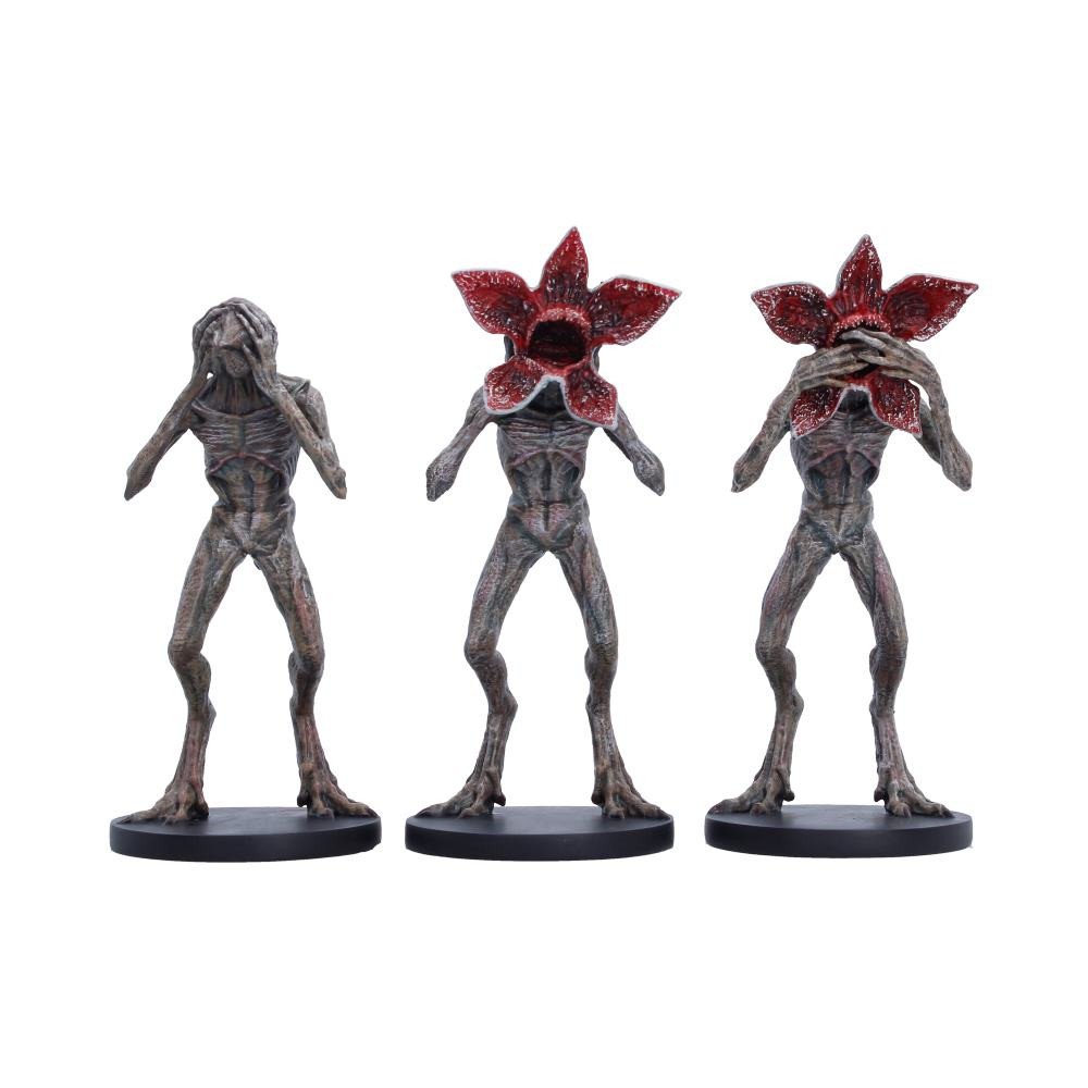 An officially licensed collectible figurine set from Stranger Things by Nemesis Now, featuring a stylised Three Wise interpretation of the terrifying Demogorgon in a playful See No Evil, Hear No Evil, See No Evil pose arrangement. Featuring three figurines standing at 16.3cm tall, they’re expertly hand-painted with detailed sculpting that captures the creatures' recognisable on-screen design while adding a unique collectible twist. Packaged in a branded protective display box designed for safe delivery and attractive presentation. Perfect for Stranger Things, collectors of horror and sci-fi memorabilia, and pop culture enthusiasts looking for distinctive display pieces. Bring iconic TV horror into your collection with this striking set that delivers instant shelf appeal and conversation-starting style.