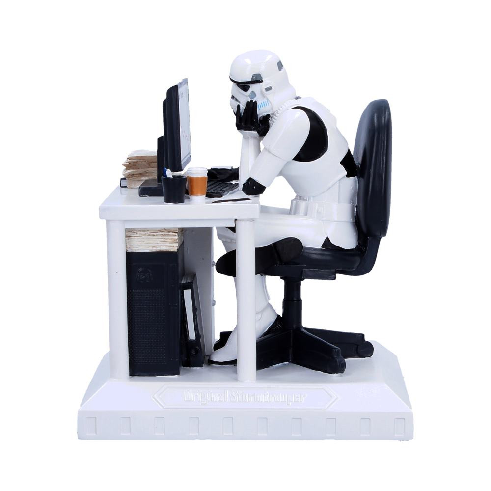 The Original Stormtrooper Slave to the Wage Figurine is a comical display piece depicting a weary trooper seated at an office desk with his head resting in one hand, offering a humorous take on the daily grind. Crafted from high-quality resin, it features detailed sculpting and hand-painted finishes that bring the classic Original Stormtrooper design together with familiar office elements such as a desk, chair, coffee cup, and folders. The figurine is securely packaged in a branded box to ensure safe arrival. Perfect for collectors of Original Stormtrooper merchandise, fans of novelty decor, and office workers alike, this light-hearted piece makes a fun and relatable addition to any desk, shelf or display.