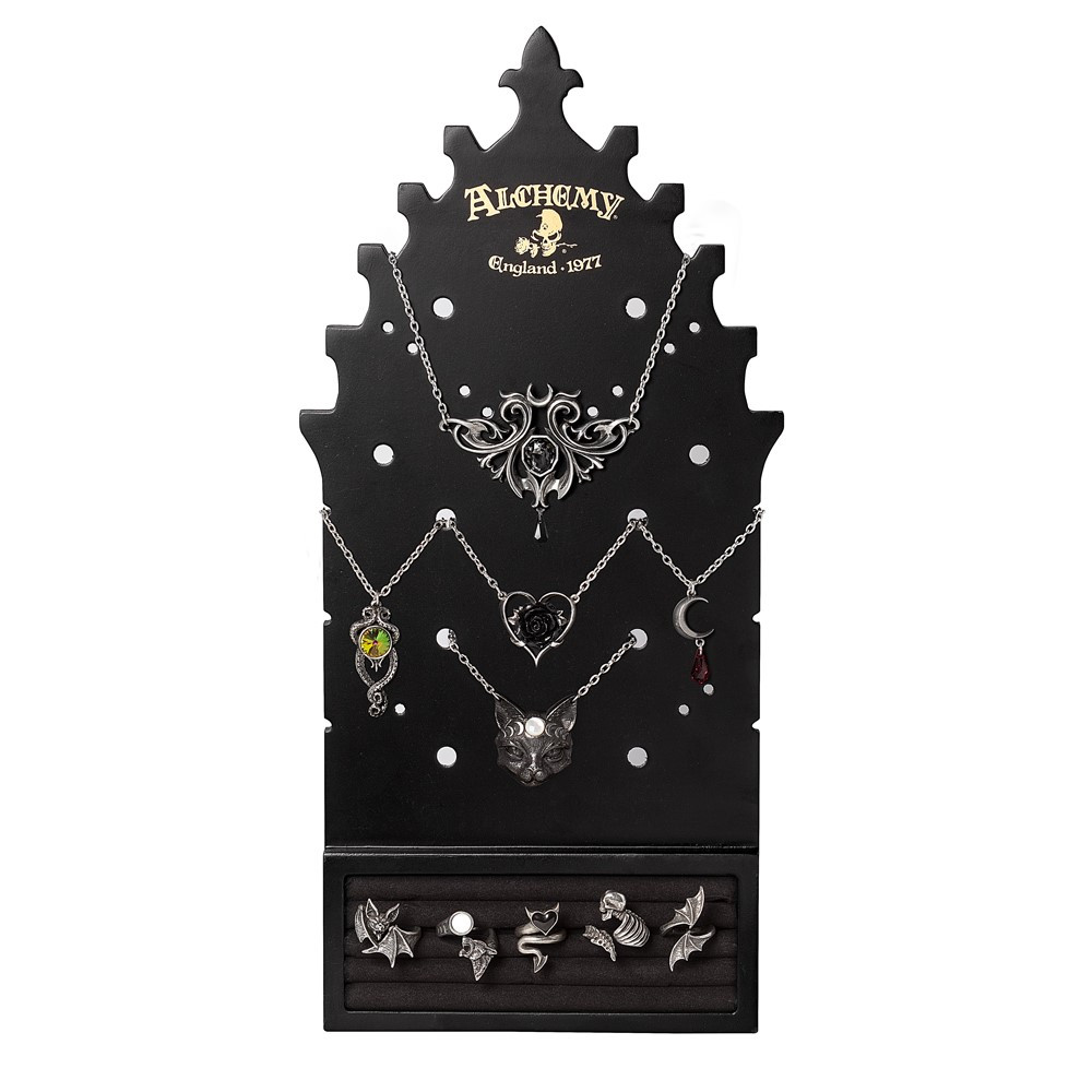 Showcase your favourite jewellery in gothic elegance with the Gothic Arch Jewellery Display Board from Alchemy. Crafted from black painted MDF (front and back), this striking display features the iconic Alchemy logo and is designed with pierced holes to organise earrings, necklaces, bracelets, and rings. Practical and versatile, the board includes iron hooks and hinges for wall mounting, as well as a fold-out stand for free-standing use. The polyester ring display section offers a refined way to present your most treasured Alchemy rings. • Shape & Finish: Gothic arch design, black painted MDF • Fittings: Iron hook and hinge for wall or tabletop display • Jewellery Storage: Pierced holes for earrings, necklaces & bracelets + polyester ring display • Branding: Features the iconic Alchemy logo • Packaging: Each piece carefully packed in a bubble bag. A unique decorative display for personal use, or an eye-catching piece for retail and jewellery presentation.