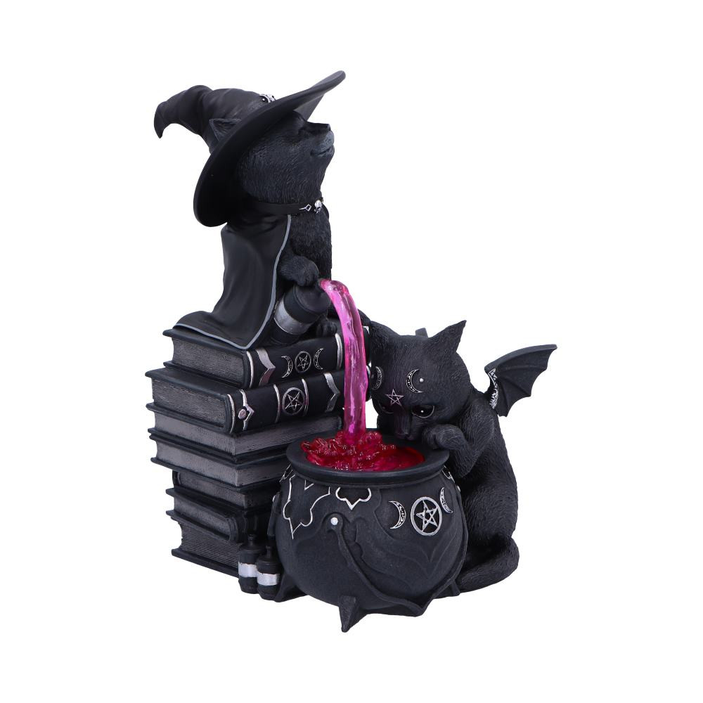 The Cult Cutie's Curious Cauldron is a spooky, cute collectible featuring the adorable Malpuss and Purrah cooking up an enchanting translucent potion. Perfect for fans of gothic, witchy, or fantasy-themed décor. Made from high-quality resin, it showcases detailed textures and hauntingly sweet expressions in a compact, display-ready size. Packaged in a Nemesis Now Branded Cult Cuties Box, it makes a great gift for witches, goths, and lovers of the strange and magical. Add a dash of dark charm to your space. The Curious Cauldron is ready to enchant your shelf.