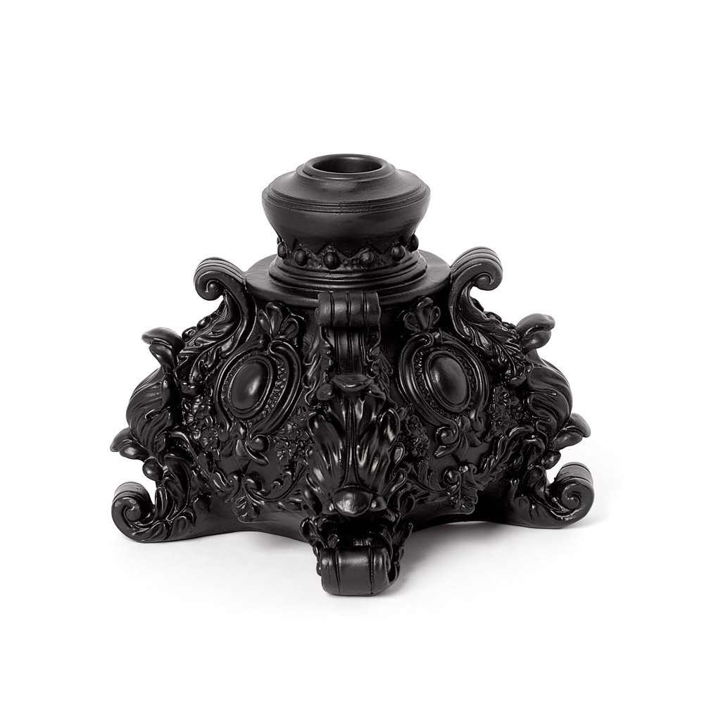 A richly ornate Rococo candlestick, adorned with elaborate scrollwork and baroque flourishes. The deep black finish enhances its dramatic silhouette, making it an ideal centrepiece for gothic table settings or decorative displays. Designed for a single candle, this resin candlestick embodies opulence, shadow, and timeless romance. • Ornate Rococo candlestick with baroque detailing • Designed for a single candle to enhance ambience • Deep black finish for a bold gothic statement • Ideal for table settings, displays, or decorative accents • Crafted from resin with intricate sculptural design • Blends opulence with dark romantic styling Colour: Black