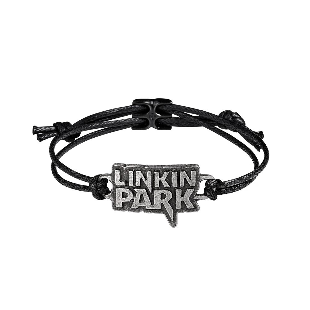 Celebrate the legacy of one of modern rock's most iconic bands with this Linkin Park lettering logo bracelet, featuring the band's bold, instantly recognisable text logo in handcrafted English pewter. Rugged and refined, the antiqued pewter emblem sits on an adjustable black cord wrist strap, secured with a sleek blackened pewter fastener for everyday comfort and edge. This bracelet channels the raw emotion and power of Linkin Park's music, making it the perfect accessory for fans who've connected with the band's evolving sound-from Hybrid Theory to Meteora and beyond. • Classic Linkin Park lettering logo in antiqued pewter • Adjustable black cord wrist strap, comfortable and durable • Finished with a blackened pewter fastener for a secure fit • Handcrafted in England from premium English pewter • Ideal for rock fans, music lovers, and alternative style enthusiasts • A subtle, wearable tribute to a band that shaped a generation • Official licensed merchandie Wear your connection to Linkin Park with this handcrafted pewter wrist strap. A powerful symbol of music, memory, and meaning.