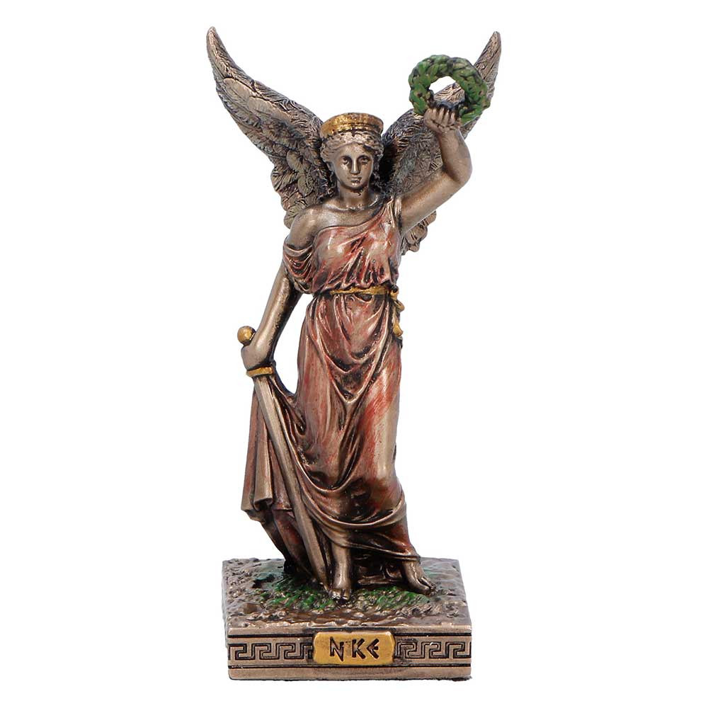 This elegant mini figurine from Nemesis Now depicts Nike, the Greek Goddess of Victory, standing in a triumphant pose with detailed wings and a laurel wreath raised above her head. Cast in high-quality resin and finished in bronze, brown, and red tones, the figurine rests on a Greek-inspired base with her name displayed on the front. Packaged in a full colour branded box with protective inner casing, it’s perfect for gifting or display. Ideal for fans of mythology, inspirational symbols, or classical decor, this timeless piece brings strength, beauty, and meaning to any space.