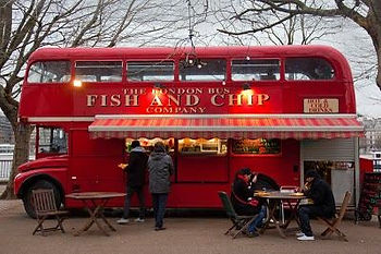 A traditional red double-decker London bus converted into a mobile Fish & Chip shop