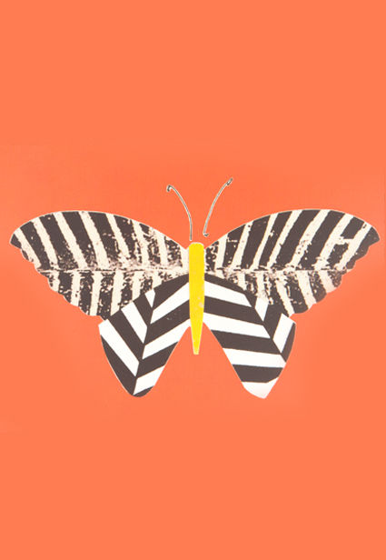 a black and white striped butterfly with a yellow tail
