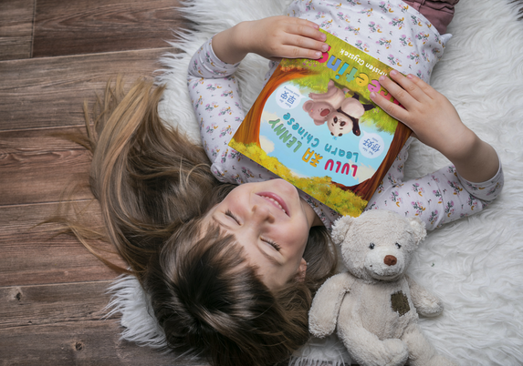 Square softcover book 7.5x7.5 in the hands of a little girl_Lulu and Lenny Learn Chinese G