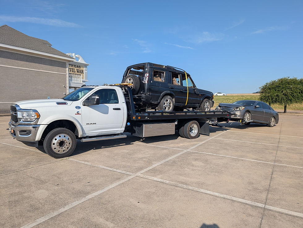 Rapid Rescue Towing truck hauling two vehicles through Fort Worth, TX