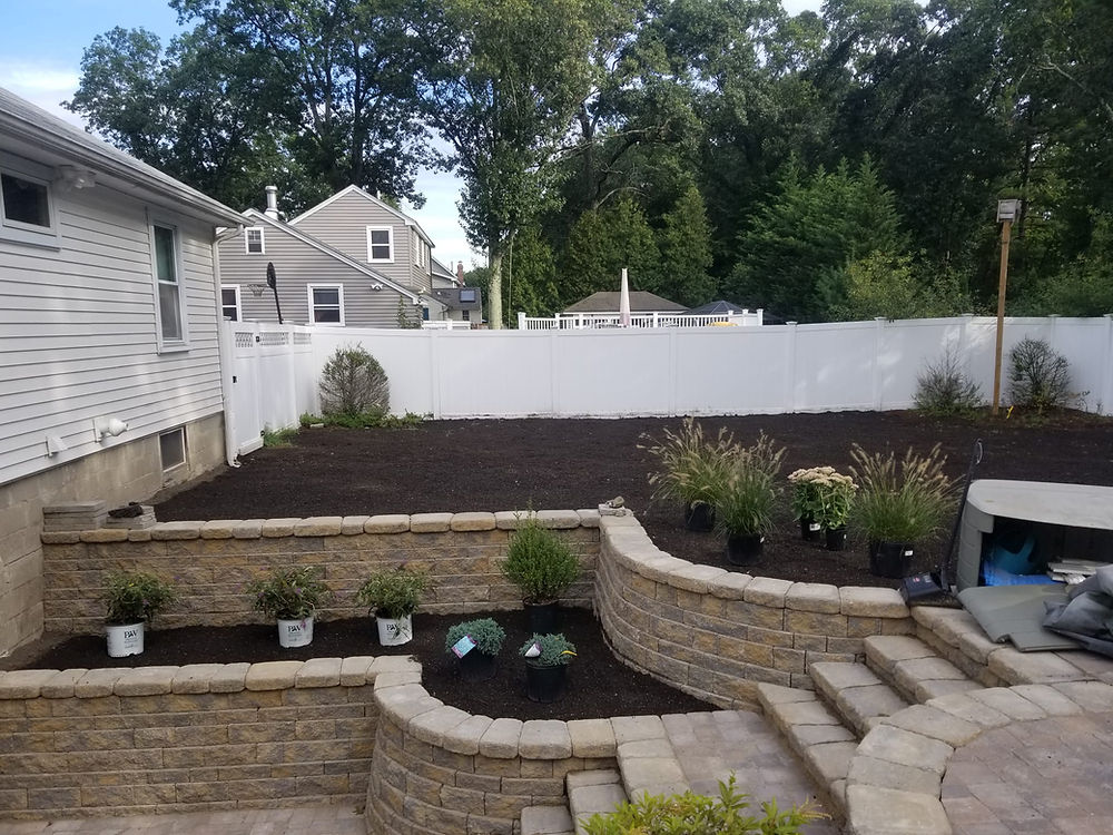 Tiered wall and patio surrounded by plants