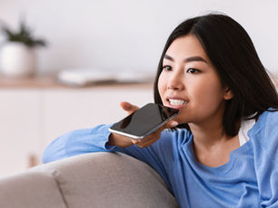 A young student talks into their cell phone.
