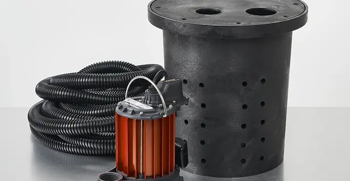 Crawlspace sump pump system with perforated basin and interior drainage pipe for groundwater removal