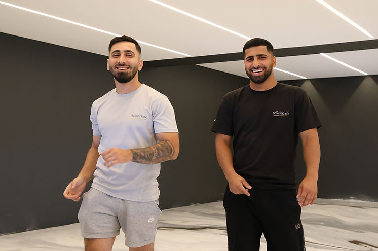 Clients admiring a high end metallic epoxy flooring Sydney installation with a decorative marble effect in a modern interior