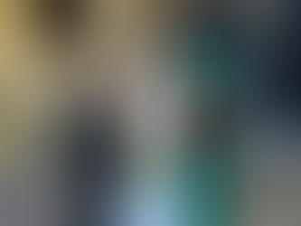 mother of the bride and her husband standing next to their daughter outside salisbury cathedral hampshire. the mother of the bride is wearing a wedding hat made by simon at marvellous millinery winchester