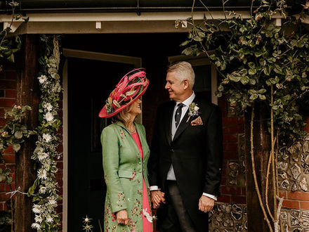 Mother of the Bride wearing a bespoke Marvellous Millinery Winchester wedding hat with a Favourbrook Womenswear coat