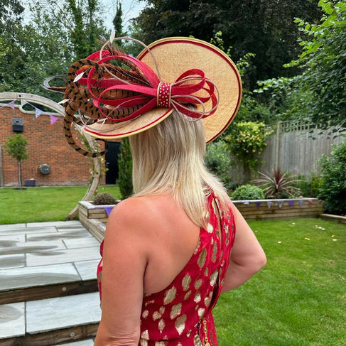 Blonde haired woman in red dress wearing wedding hat; Crafting the Perfect Mother of the Groom Hat – with Rixo Dress & Dior Sandals