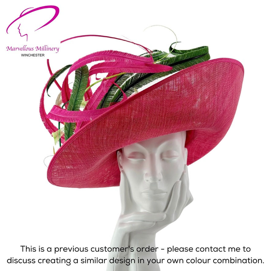 Bespoke wedding hat for Mother of the Bride featuing a large upturned brim in raspberry sinamay and a generous mount of curled ostrich feathers.