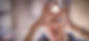 Older woman looking through her hands in a heart shape