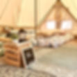 Interior of a CampLight glamping tent showing a king bed and decorations