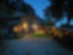 Sunset atmosphere at a Tuscan farm-to-table experience in a stone farmhouse decorated with lights and candles