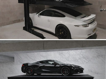 Car on a residential parking lift inside a home garage