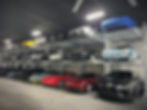 sport cars collection stacked on an OMER Tripark 2-post parking lift