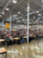 Wide angle view of a school playground with students playing and trees surrounding the area