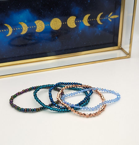 a pile of handmade beaded bracelets in many varieties