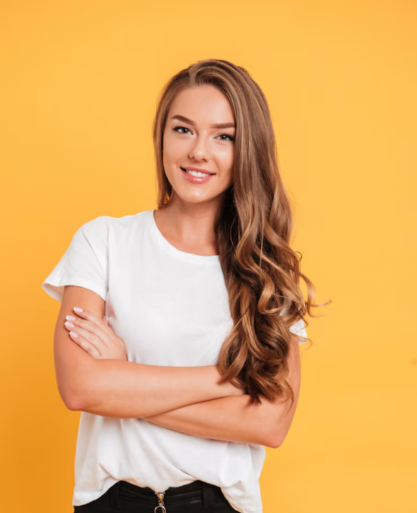 Smiling woman with arms crossed, wearing white t-shirt