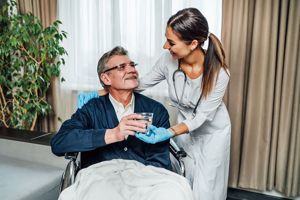 older-man-wheelchair-smiles-nurse-assistant-she-hands-him-glass-water.jpg