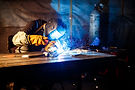 Satisfied customer using Welders Log on a tablet in a welding shop