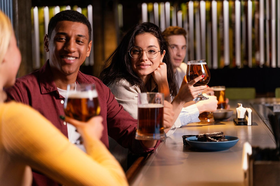 Friends socializing at a bar with beer