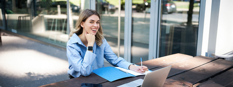 happy-saleswoman-taking-notes-working-outdoors-fresh-air-sitting-with-laptop-outside-offic