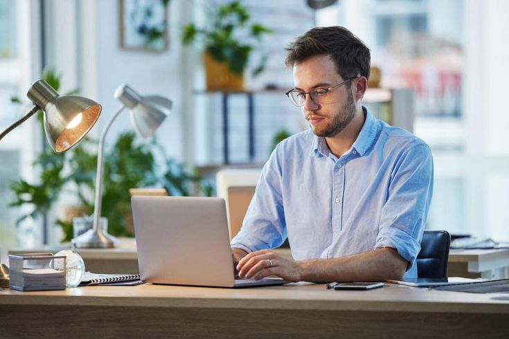A man working on her lap[top