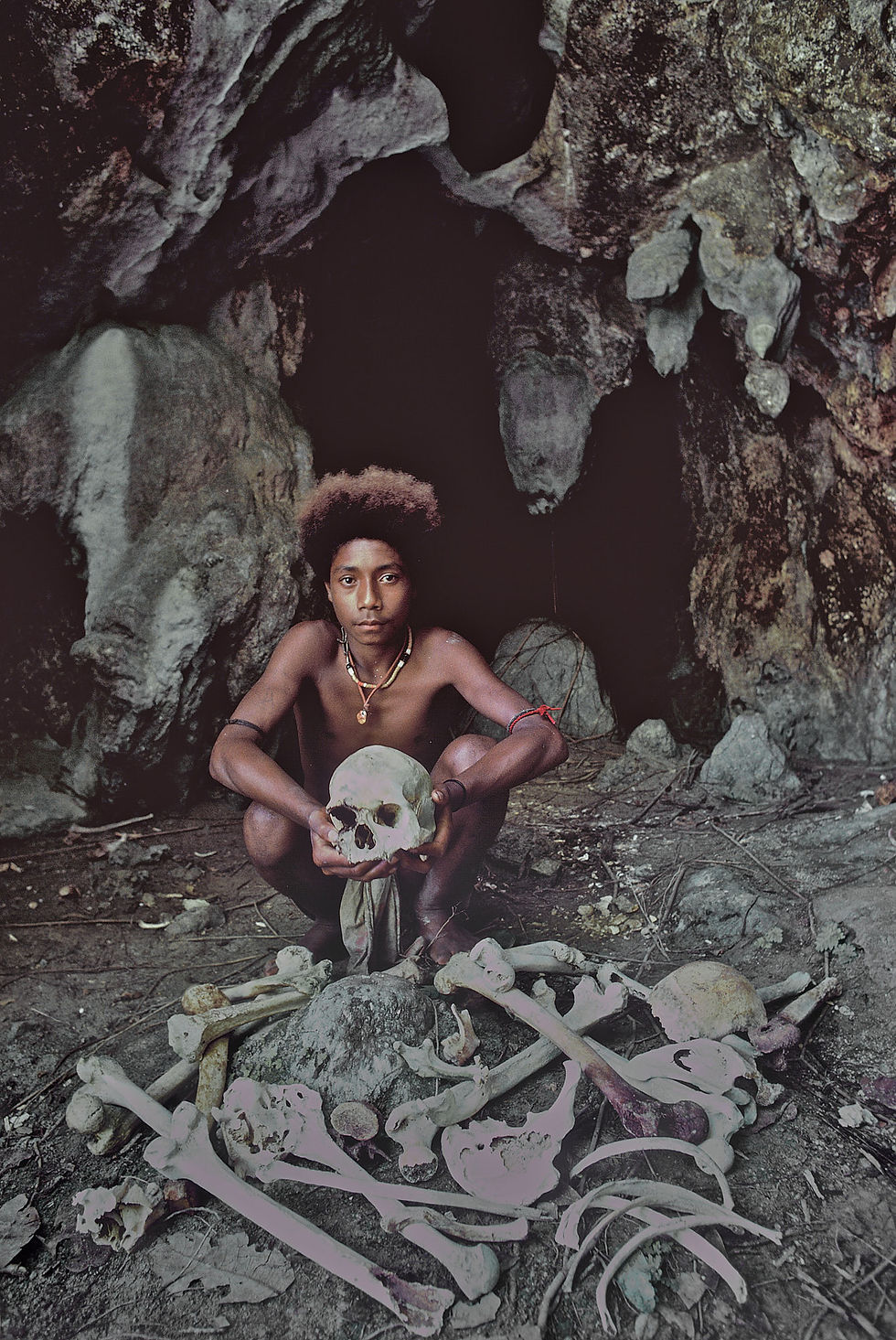 Yamama holds an ancestral skull in a cave off the beach