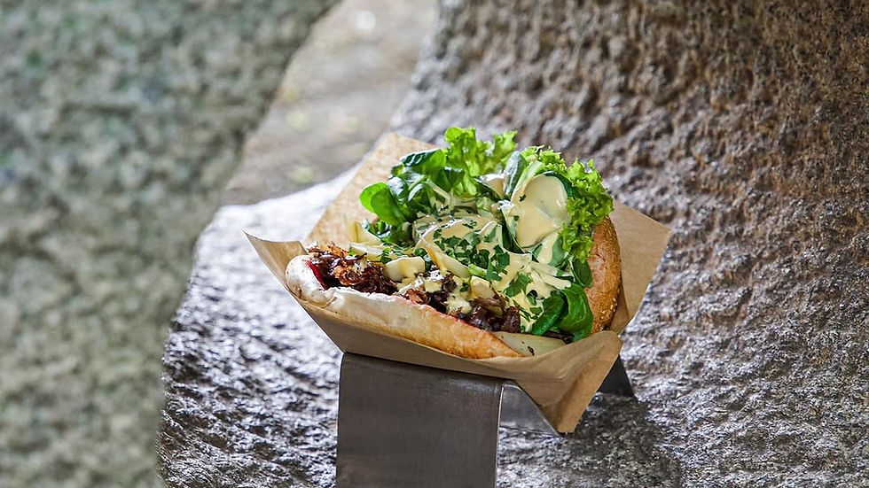 Overhead view of Kebap with Attitude’s Beelitzer Art kebap, featuring Beelitz white asparagus, jam, hollandaise, and crisp greens.