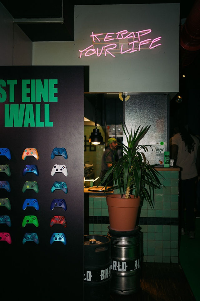 Display of colorful personalized XBOX controllers at the Kebap with Attitude and XBOX collaboration event in Berlin.