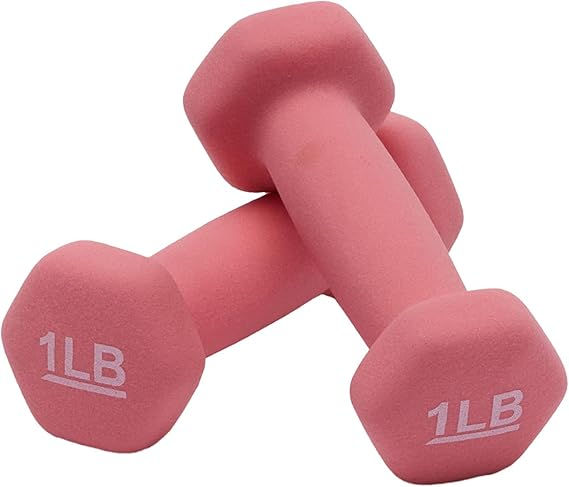 Two pink 1LB dumbbells on a white background, stacked in a crossed arrangement. The dumbbells have a soft matte texture.