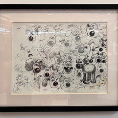 A framed picture of original sketches of Gromit dogs