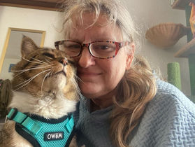 A photo of a woman with a cat.