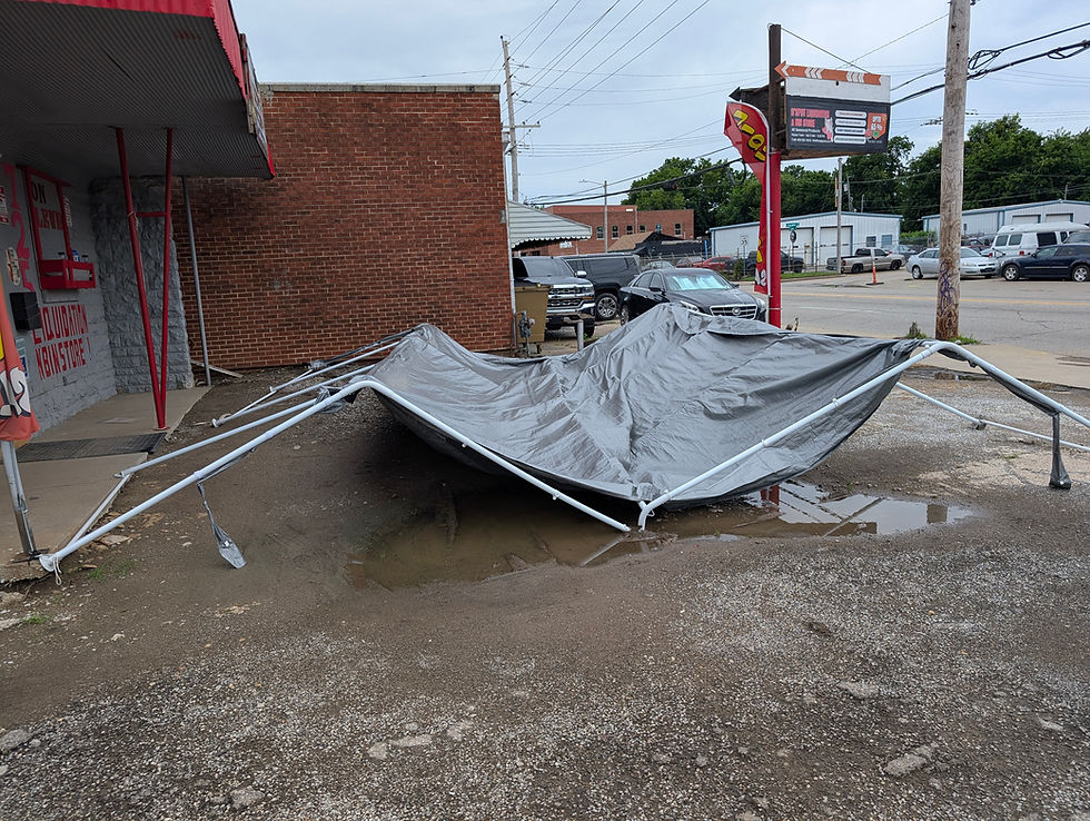Eye-level view of a torn outreach tent collapsed on the ground