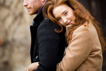 Smiling woman rests head on man's shoulder